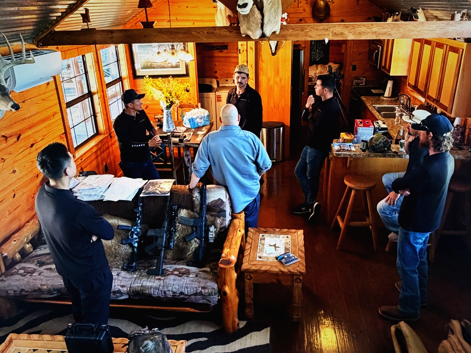 Hunters, dealers, creators, and partners gathered inside the lodge during the Summer Sundown Shoot